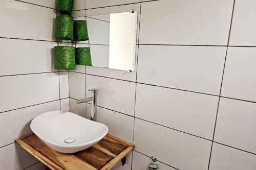 a bathroom with a white toilet and a mirror at Bungalow Ramena beach Antsiranana in Andjamen