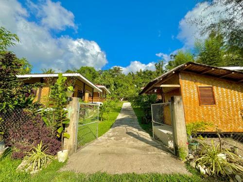 a gate to a house with a fence at LUZVILLE Transient House - Port Barton in Itaytay