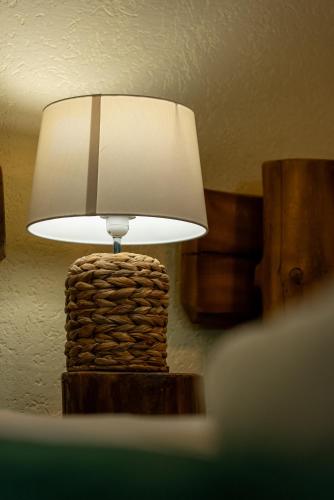 a lamp sitting on a table in a room at ȘURA LU' PĂTRU in Vulcan