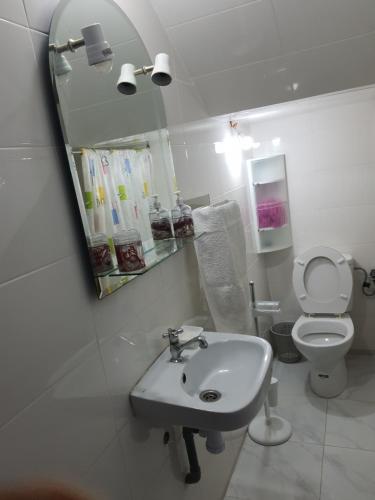 a bathroom with a sink and a toilet and a mirror at Marrakech in Marrakech