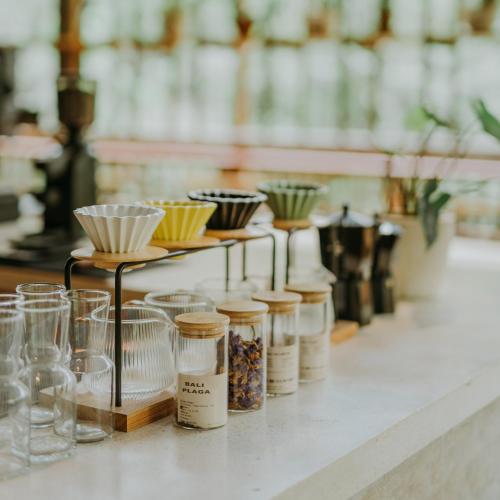 a row of jars and glasses on a counter at Glamping tent in Pelaga Eco Park in Patjung