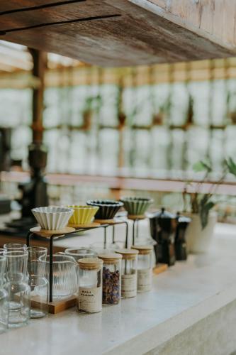 a counter with a bunch of jars and plants at Glamping tent in Pelaga Eco Park in Patjung