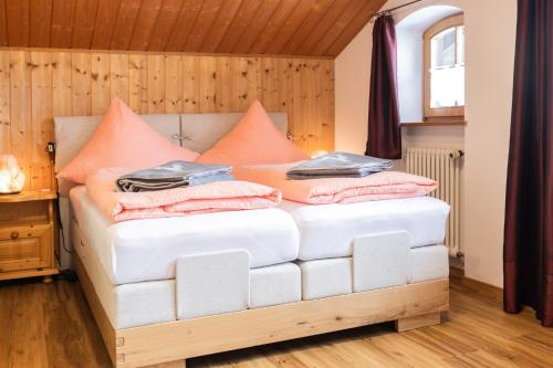 a bed with pillows on it in a room at Ferienwohnungen Oberstdorf Schwartges in Oberstdorf