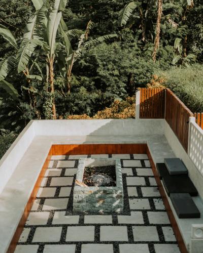 a fire pit in the middle of a patio at Glamping tent in Pelaga Eco Park in Patjung