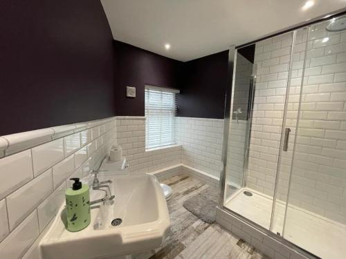 biała łazienka z umywalką i prysznicem w obiekcie Peak District Stay Stylish for 2 Pass the Keys w mieście New Mills