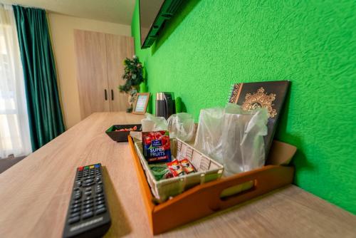 a box of candy on a bed with a remote control at ȘURA LU' PĂTRU in Vulcan