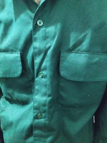 a close up of a green shirt with a pocket at Buddha villa in Patna