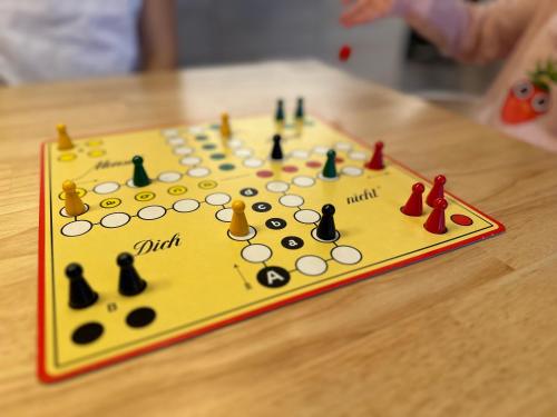 a yellow board with chess pieces on it on a table at Apartment Strandzeit in Kolpinsee