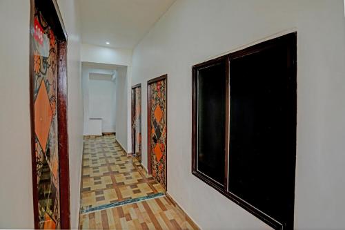 a hallway with paintings on the wall and a window at Hotel Starlight in Lucknow