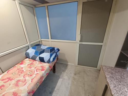 a room with a bed and some glass doors at snooze 3 in Panchkula