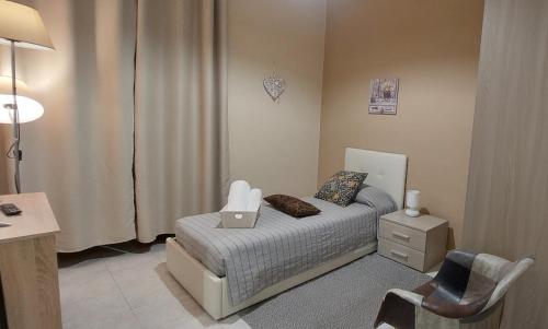 a small bedroom with a bed with a laptop on it at La Maison - Short Rental in Campobasso