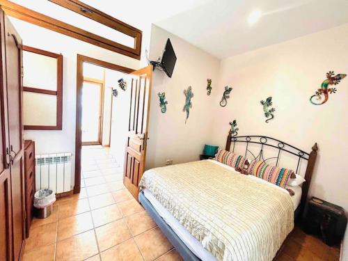 a bedroom with a bed and bikes on the wall at Villa Alta Vista in Zahara de los Atunes