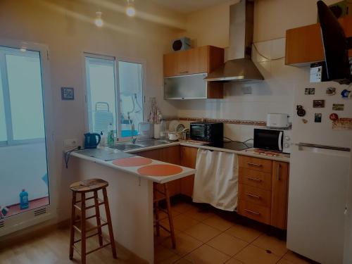 a kitchen with a white refrigerator and a counter at Cozy Private Room 1 in Valencia