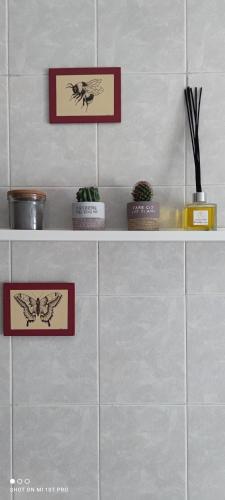 a shelf with three pictures on the wall at B&B Al 27 in Paderno dʼAdda