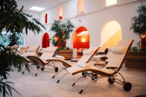 a row of chairs in a waiting room with surfboards at Hotel Calamus - 4 Sterne Superior in Kehl am Rhein