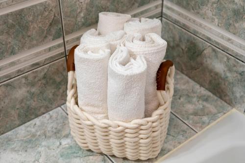 a basket of towels sitting on a counter in a bathroom at Holiday house "Dolka" in Postira