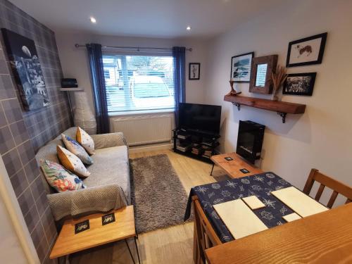 a living room with a couch and a table at The Annex in Cemaes Bay