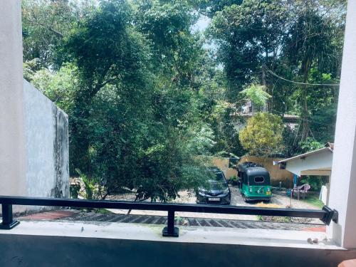 a view from a window of a yard with a green truck at Center Point Villa Unawatuna in Unawatuna