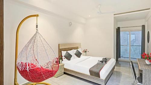 a bedroom with a bed with a hanging hammock at Boutique Hotel Blue shine Noida in Noida