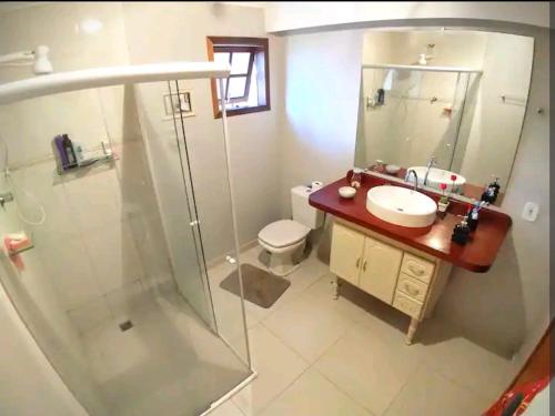 a bathroom with a shower and a sink and a toilet at Casa Colonial in São Lourenço