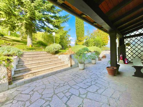 a patio with stairs and potted plants on it at Mazzetti Country House-Vita in campagna con giardino in Vimignano