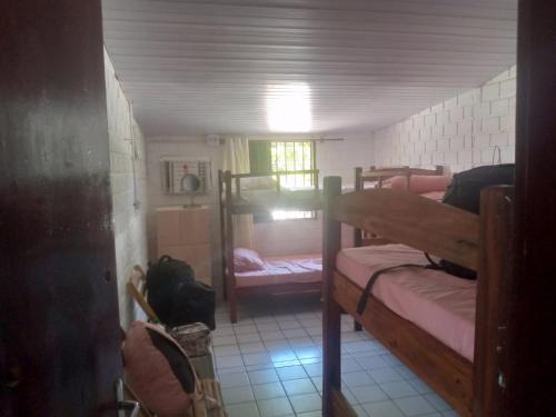 a room with two bunk beds in a room at Hostel Porto Vip in Porto De Galinhas