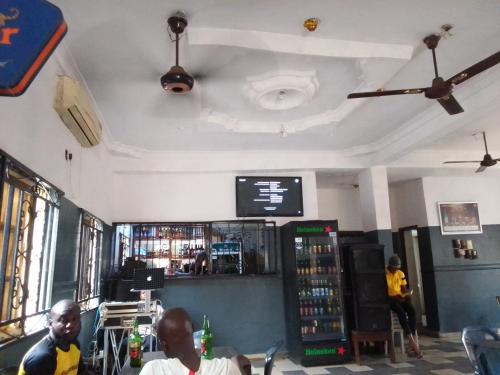 a bar with two men sitting at a table in a restaurant at MARVELLOUS hotel in Lagos