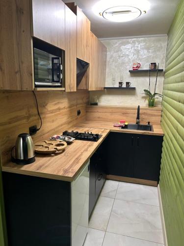 a kitchen with a sink and a stove top oven at Khatky Na Penkakh in Vorokhta