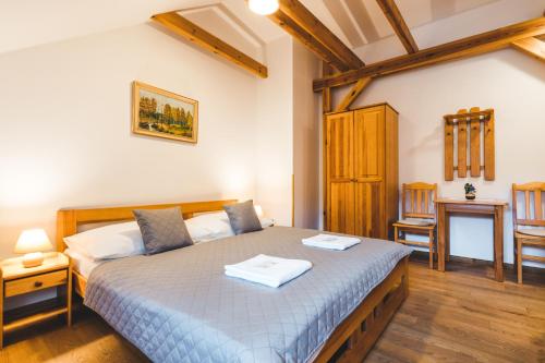 a bedroom with a bed with two towels on it at Pension Krumau in Český Krumlov