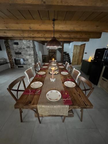 a long wooden table in a room with chairs at Hamerská chaloupka in Hlinsko