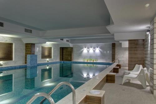 a large swimming pool in a hotel room with a swimming pool at Hotel Monte Cristo in Blagoevgrad