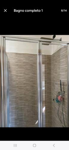 a shower with a glass door in a bathroom at Baita Camoscio in Dimaro