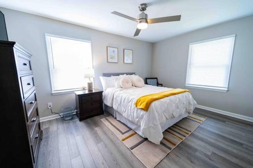 een slaapkamer met een bed en een plafondventilator bij Prime location that feels like home away from home in Greensboro