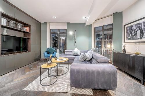 a living room with two couches and a tv at The Soho STAR in London