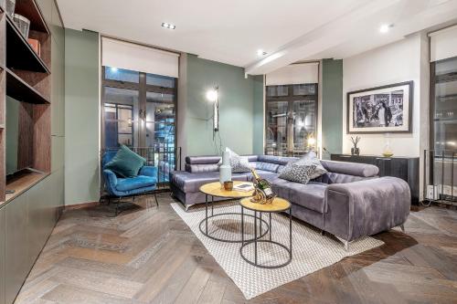 a living room with a couch and a table at The Soho STAR in London