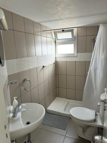 a bathroom with a sink and a toilet and a shower at Anastasia 1 Bedroom Apartment in Limassol