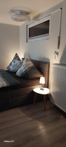 a living room with a bed and a table at Ferienwohnung oder Studio Dresden-Neustadt inkl Parkplatz mit Balkon oder Terrasse in Dresden