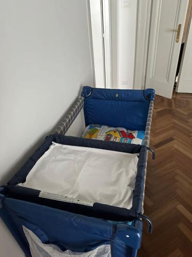 a blue suitcase sitting on the floor in a room at Botta 9 in Bergamo
