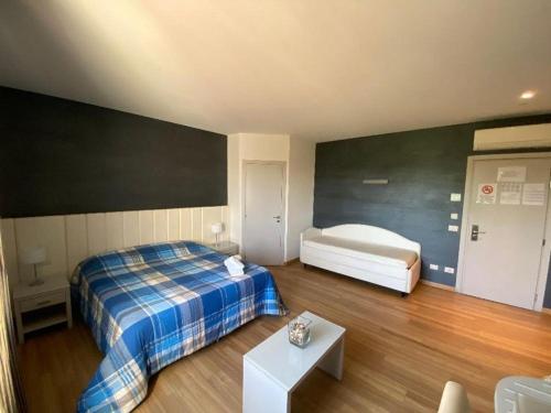 a bedroom with a bed and a table in it at Locanda LaRotonda in Villa Verucchio