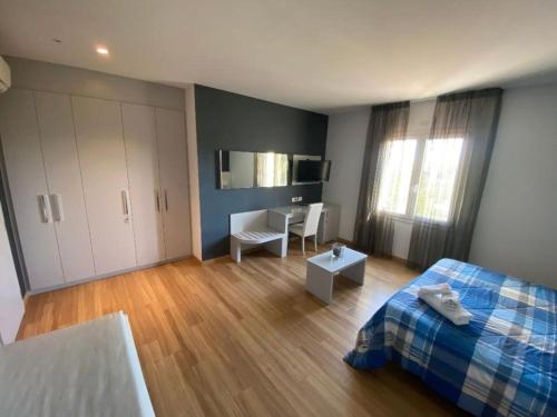 a bedroom with a bed and a desk in it at Locanda LaRotonda in Villa Verucchio