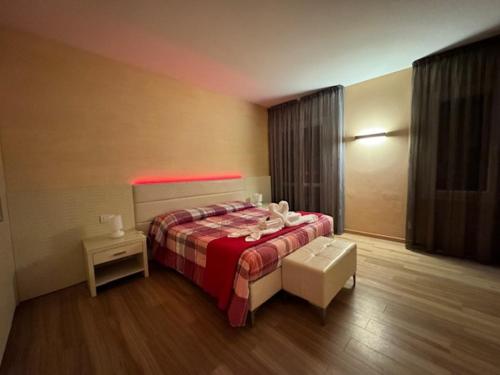 a bedroom with a bed with a red blanket at Locanda LaRotonda in Villa Verucchio