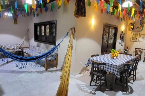 a room with a table and a hammock in it at Solar Serra Negra Bezerros - PE in Bezerros