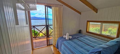 a bedroom with a bed and a view of the ocean at Little Haven 10 & 12 in Hermanus