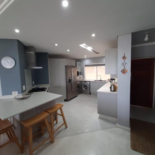 a kitchen with a table and chairs in it at 10 LA TORNYN, GLENTANA in Groot Brak Rivier