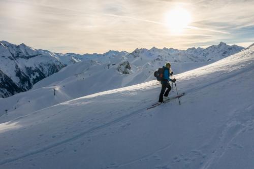 a man is skiing down a snow covered mountain at Appartements Mary inklusive Tauern-Spa Kaprun in Kaprun