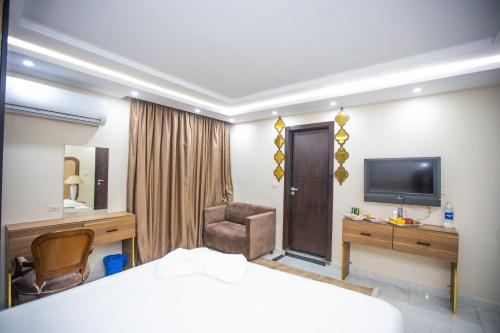 a hotel room with a bed and a television at New Comfort Inn Giza in Cairo
