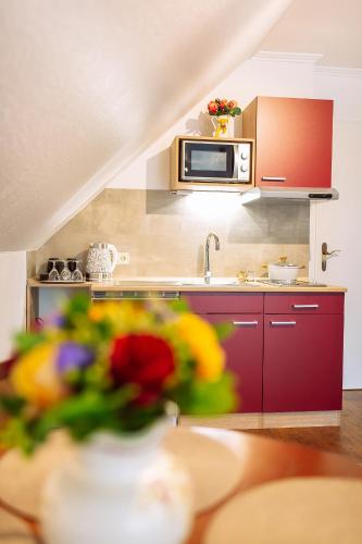 a kitchen with a sink and a microwave at Apartment am Tannenweg in Badenweiler