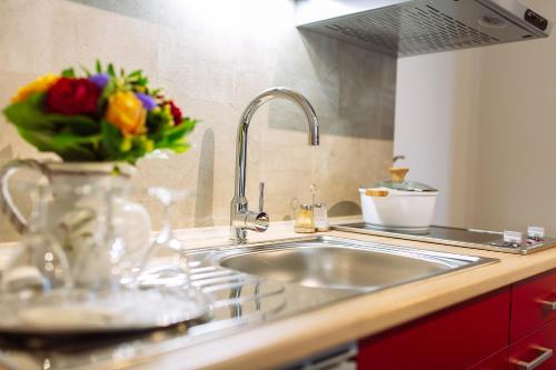 a kitchen with a sink and a vase of flowers at Apartment am Tannenweg in Badenweiler