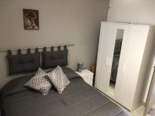 a bedroom with a bed with two pillows and a mirror at CASA DIANA in Lipari