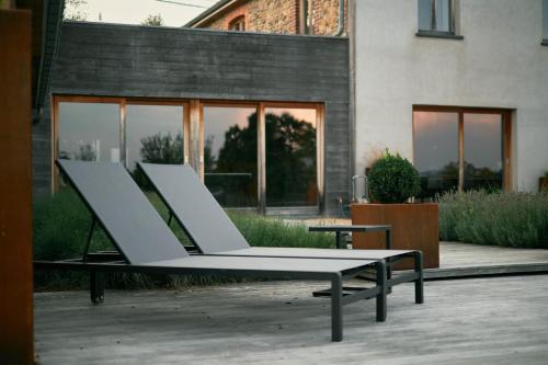a group of white chairs sitting outside of a building at OKLM in Stavelot